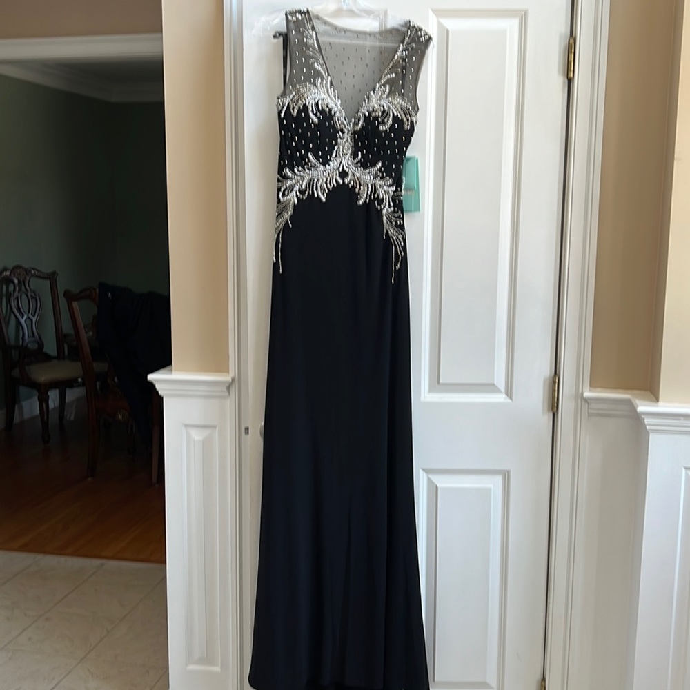 Evening gown. Fitted sleeveless black with sequins and pearls.